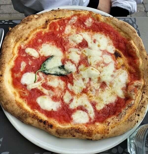 Authentic Neapolitan Margherita pizza with fresh tomato, mozzarella, and basil