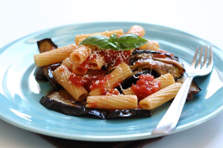 Pasta alla Norma: Sicilian pasta with eggplant, tomato sauce, ricotta salata, and basil.