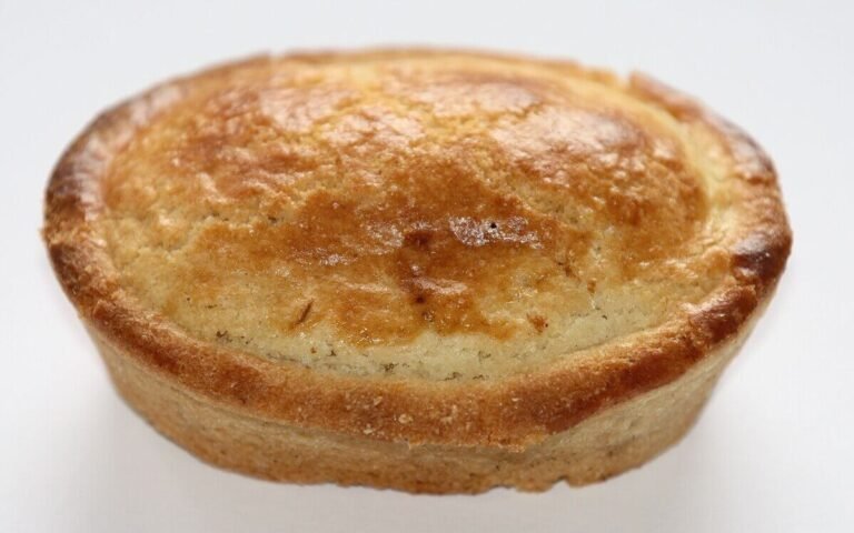 Warm Pasticciotto Leccese with golden crust and lemon-vanilla custard filling. Traditional Puglian Custard-Filled Pastry