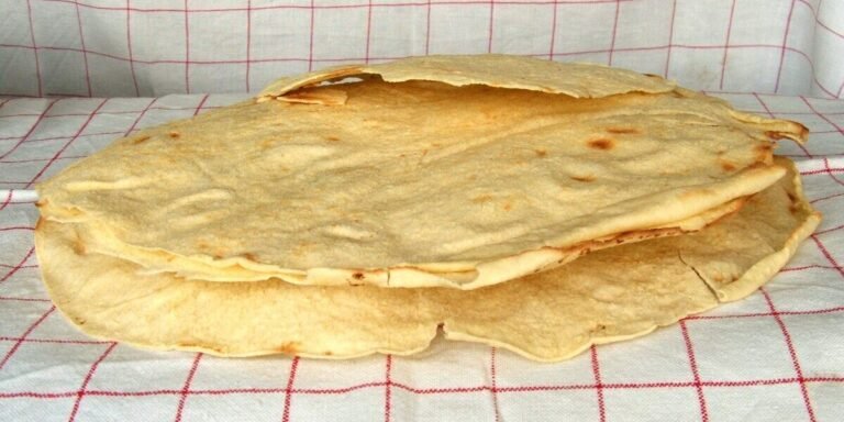 Traditional Sardinian Pane Carasau crispy bread on wooden table