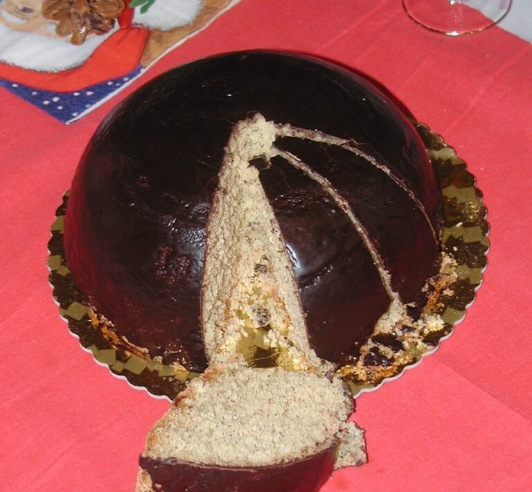 Traditional Parrozzo cake from Abruzzo with almond semolina base and glossy dark chocolate glaze, Italian Christmas dome-shaped dessert.