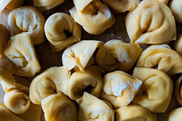 Homemade Italian tortellini – traditional fresh pasta filled with pork, prosciutto, mortadella and Parmigiano Reggiano