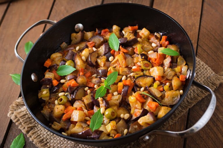 Traditional Sicilian Caponata with eggplant, tomatoes, olives, capers, and sweet-sour agrodolce sauce