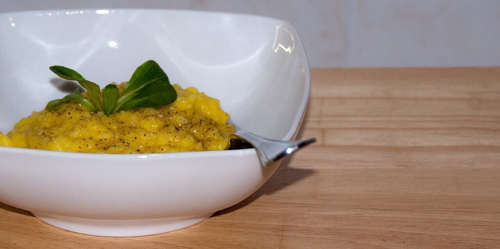 Traditional Risotto alla Milanese served creamy and golden with saffron and Parmesan cheese.