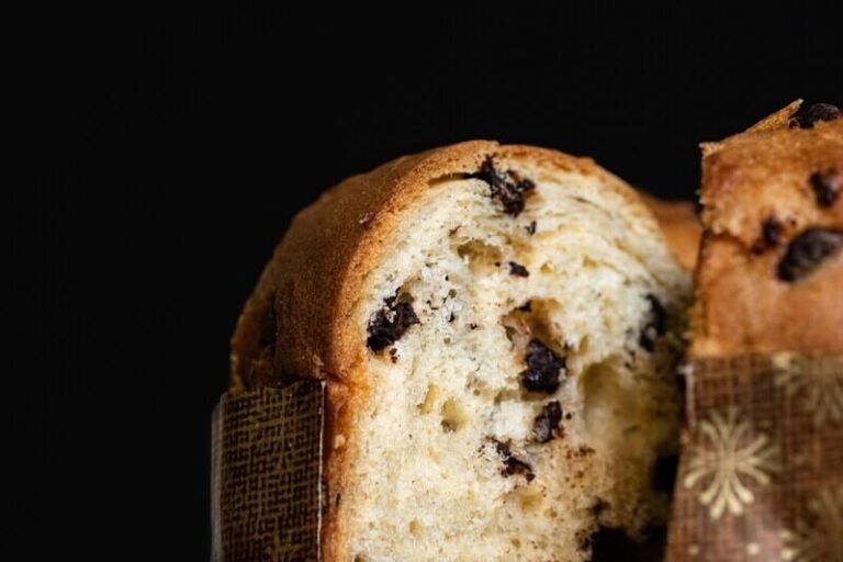 Slice of homemade Italian Chocolate Panettone – soft interior filled with melted dark chocolate, perfect for Christmas breakfast or gifting.